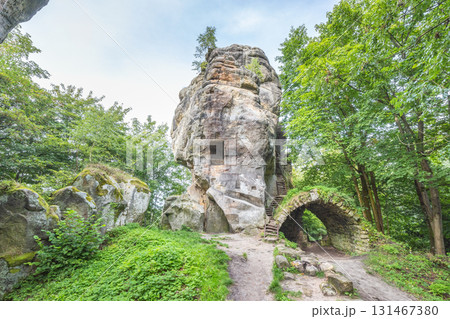 Landscape of Adrspach-Teplice Rocks area, in Hradec Kralove Region in the Czech Republic, Europe. Unique rock formation with carved steps and an arch, surrounded by green trees and a path in nature. Landscape of Adrspach-Teplice Rocks area, in Hradec Kralove Region in the Czech Republic, Europe. Unique rock formation with carved steps and an arch, surrounded by green trees and a path in nature. 131467380