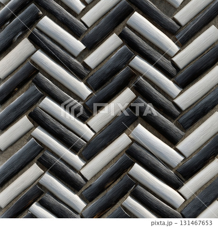 Close up of herringbone pattern made from bamboo strips dyed in charcoal and cream, creating textured and stylish design. alternating colors add depth and contrast 131467653