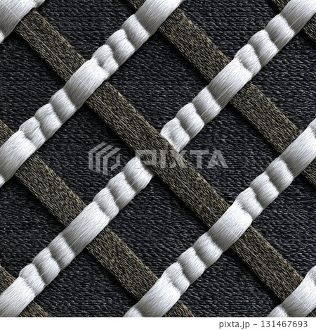 Close up of woven pattern featuring charcoal and white colors, showcasing crisscross design with textured surface. intricate weave creates striking visual effect 131467693