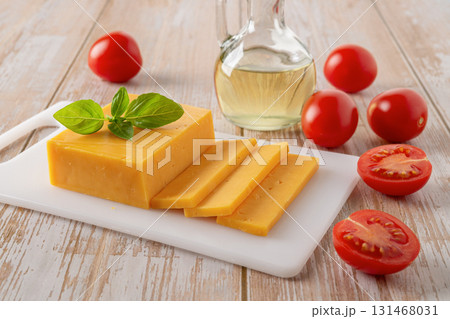 Slised cheddar cheese and tomatoes close-up. Slised cheddar cheese and tomatoes close-up. 131468031