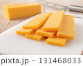 Sliced cheddar cheese close-up. 131468033