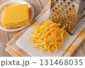 Whole and shredded cheddar cheese close-up. 131468035