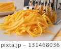 Shredded cheddar cheese close-up. 131468036