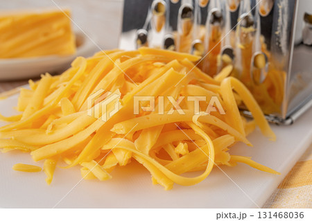 Shredded cheddar cheese close-up. 131468036
