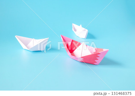 Leadership concept.Group of origami boats on blue. 131468375