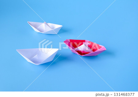 Leadership concept.Group of origami boats on blue. 131468377