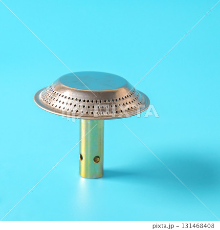 Spares part of steel metal gas burner head on background. 131468408