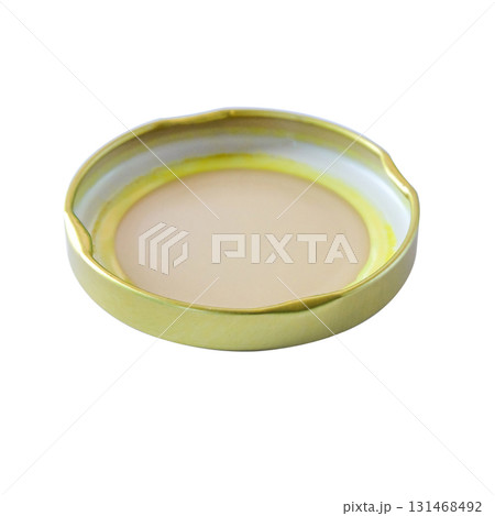A golden jar lid or cap on background. A golden jar lid or cap on background. 131468492