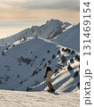 Skier watching sunset in the mountains 131469154