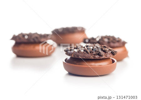 Sweet chocolate pralines. Chocolate candies isolated on white background. 131471003