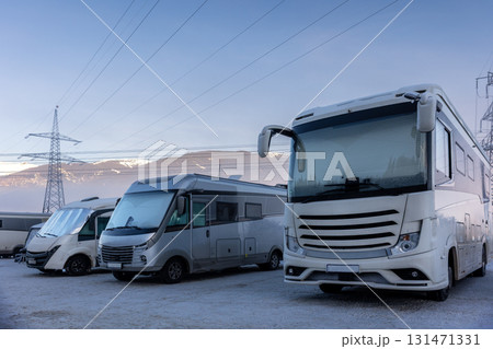 Scenic many different modern campervan motor home van parked camper park site lot Austria at sunrise sunset Kaprun mountain landscape. Motorhome campground station travel destination. RV lifestyle Scenic many different modern campervan motor home van parked camper park site lot Austria at sunrise sunset Kaprun mountain landscape. Motorhome campground station travel destination. RV lifestyle 131471331