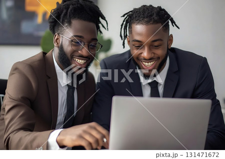Employee collaboration on a laptop in a modern office setting during a productive work session 131471672