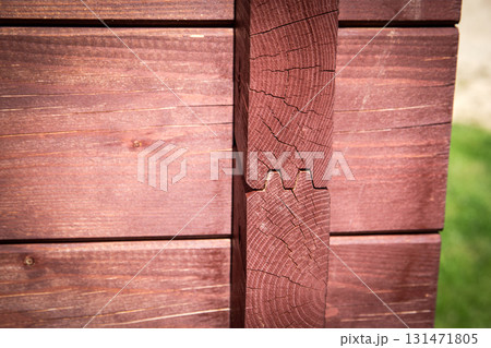 Close-Up of Interlocking Timber Corner in Sunlight on Wooden Cabin Wall. 131471805