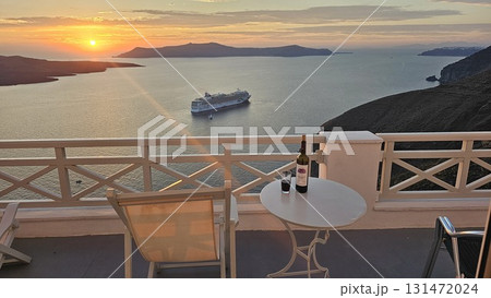 Scenic sunset view from a Santorini terrace overlooking the Aegean Sea, 131472024