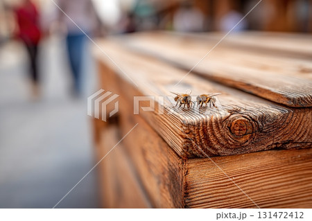 Coffee cup resting on wooden table with sunglasses and book in bright outdoor setting 131472412