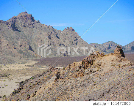 Rugged Volcanic Landscape with Rocky Mountains under Clear Blue Sky in Teide National Park, Tenerife Rugged Volcanic Landscape with Rocky Mountains under Clear Blue Sky in Teide National Park, Tenerife 131472806