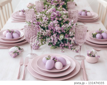 Light Minimal purple speckled Easter eggs with ceramic tableware and cherry blossoms on white linen table for top view, flat lay fresh spring decor concept. 131474335