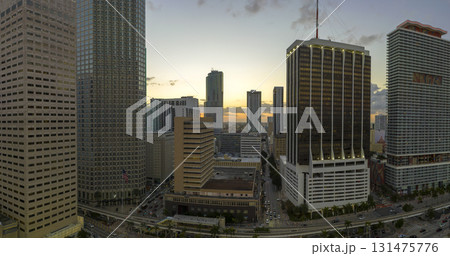 View from above of skyscraper buildings and urban traffic in downtown district of Miami Brickell in Florida, USA at sunset. American megapolis with business financial district at nightfall View from above of skyscraper buildings and urban traffic in downtown district of Miami Brickell in Florida, USA at sunset. American megapolis with business financial district at nightfall 131475776