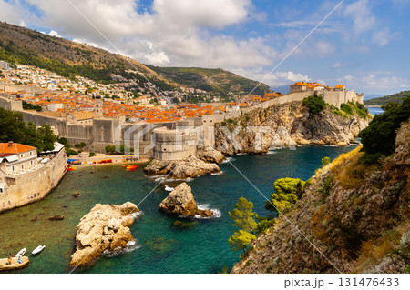 Vivid contrast of blue sky and red tiled roofs is hallmark of Dubrovnik Fortress. Vivid contrast of blue sky and red tiled roofs is hallmark of Dubrovnik Fortress. 131476433