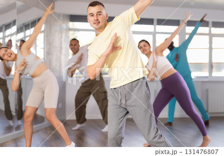 Young man practicing hip-hop dance in training hall 131476807