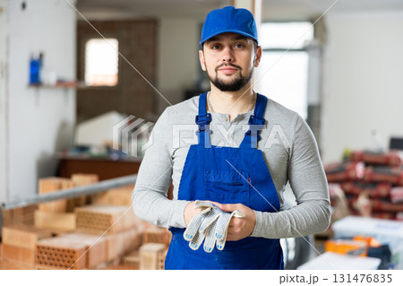 Portrait of a builder standing on a construction site indoors Portrait of a builder standing on a construction site indoors 131476835