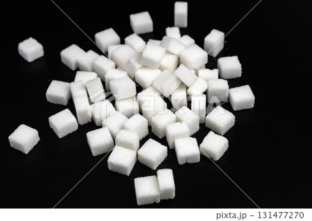 Cubes of white refined sugar on a black background 131477270