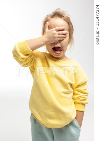 Portrait of funny little girl with funny emotions on her face. Pretty smile kid in studio on white background. High quality photo Portrait of funny little girl with funny emotions on her face. Pretty smile kid in studio on white background. High quality photo 131477274