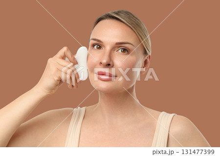 Woman enjoys a soothing facial treatment with gentle movements 131477399