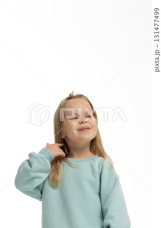 Portrait of funny little girl with funny emotions on her face. Pretty smile kid in studio on white background. High quality photo 131477499