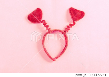 Valentine's Day art composition with red headband heart-shaped on pink surface. Valentine celebration concept. Flat lay, top view, copy space, greeting card Valentine's Day art composition with red headband heart-shaped on pink surface. Valentine celebration concept. Flat lay, top view, copy space, greeting card 131477731