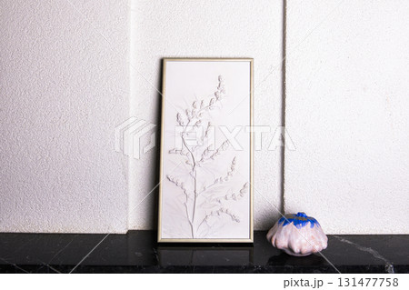 Stylish living room interior with botanical bas-relief wildflowers for wall art and white blue pumpkins. 3D Flower plaster and halloween decor. Modern and luxury interior of room. High quality photo 131477758