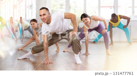 Group of people warming up before dance class Group of people warming up before dance class 131477761