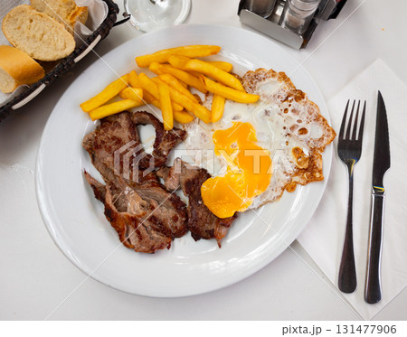 Veal with eggs and potatoes on a plate Veal with eggs and potatoes on a plate 131477906