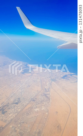 View from the window of plane on blue sky and earth with landscape of desert, sea and canals in Emirates. High quality photo View from the window of plane on blue sky and earth with landscape of desert, sea and canals in Emirates. High quality photo 131478093