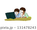 寝転がってタブレットを見る子どもたち 131478243