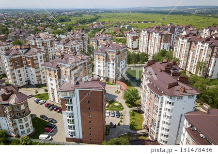 Top view of apartment or office tall buildings, parked cars, urban city landscape. Drone aerial photography. Top view of apartment or office tall buildings, parked cars, urban city landscape. Drone aerial photography. 131478436