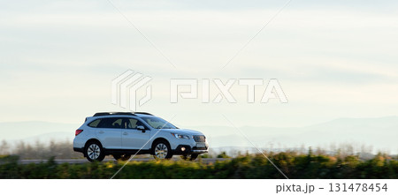 SUV car driving fast on intercity road at sunset. Highway traffic in evening SUV car driving fast on intercity road at sunset. Highway traffic in evening 131478454