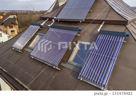 Solar water heating system on house roof. Hot water boiler, alternative ecological sun energy generator. Solar water heating system on house roof. Hot water boiler, alternative ecological sun energy generator. 131478482