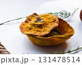 Dried pumpkin - container with a lid and a dried mandarin with a leaf, horsetail, and a spruce cone on a white background. Still life. 131478514
