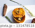 Dried pumpkin - container with a lid and a dried mandarin with a leaf, horsetail, and a spruce cone on a white background. Still life. 131478518