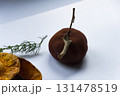 Dried pumpkin - container with a lid and a dried mandarin with a leaf, horsetail, and a spruce cone on a white background. Still life. 131478519