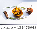 Dried pumpkin - container with a lid and a dried mandarin with a leaf, horsetail, and a spruce cone on a white background. Still life. 131478643