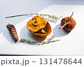Dried pumpkin - container with a lid and a dried mandarin with a leaf, horsetail, and a spruce cone on a white background. Still life. 131478644