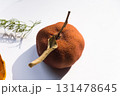 Dried pumpkin - container with a lid and a dried mandarin with a leaf, horsetail, and a spruce cone on a white background. Still life. 131478645