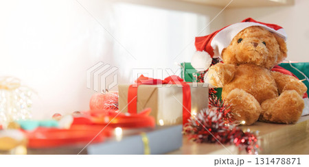Teddy Bear in Santa Hat Surrounded by Christmas Gifts 131478871