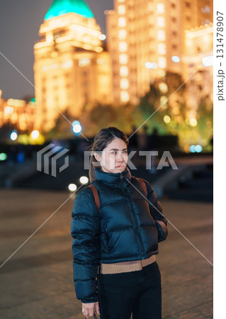 woman traveler visiting in Shanghai, China. Happy Female Tourist sightseeing Shanghai view in The Bund of Shanghai at night. landmark and popular for tourism attractions. Travel and Vacation concept woman traveler visiting in Shanghai, China. Happy Female Tourist sightseeing Shanghai view in The Bund of Shanghai at night. landmark and popular for tourism attractions. Travel and Vacation concept 131478907