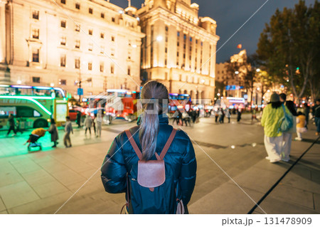 woman traveler visiting in Shanghai, China. Happy Female Tourist sightseeing Shanghai view in The Bund of Shanghai at night. landmark and popular for tourism attractions. Travel and Vacation concept woman traveler visiting in Shanghai, China. Happy Female Tourist sightseeing Shanghai view in The Bund of Shanghai at night. landmark and popular for tourism attractions. Travel and Vacation concept 131478909