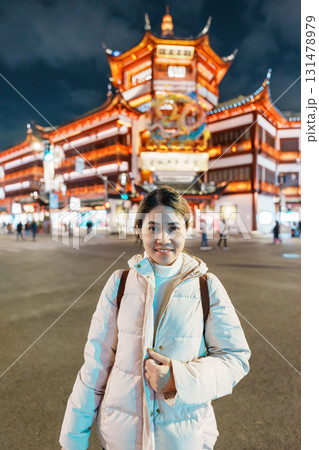 woman traveler visiting in Shanghai, China. Happy Female Tourist sightseeing and shopping in Yuyuan Old Street market at night. landmark and popular for tourism attractions. Travel and Vacation woman traveler visiting in Shanghai, China. Happy Female Tourist sightseeing and shopping in Yuyuan Old Street market at night. landmark and popular for tourism attractions. Travel and Vacation 131478979