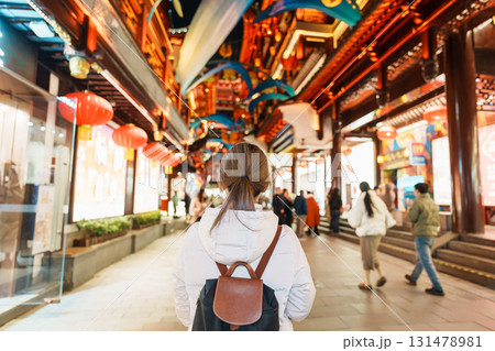 woman traveler visiting in Shanghai, China. Happy Female Tourist sightseeing and shopping in Yuyuan Old Street market at night. landmark and popular for tourism attractions. Travel and Vacation woman traveler visiting in Shanghai, China. Happy Female Tourist sightseeing and shopping in Yuyuan Old Street market at night. landmark and popular for tourism attractions. Travel and Vacation 131478981
