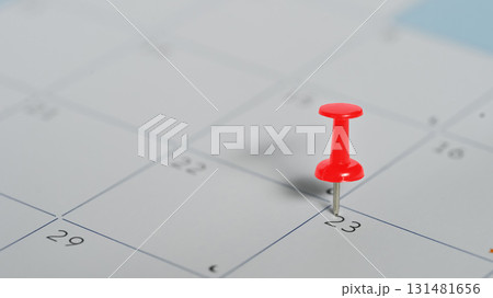 Red push pin marking the 23rd on a calendar, concept of appointment and important date planning Red push pin marking the 23rd on a calendar, concept of appointment and important date planning 131481656